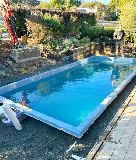 Clear-blue fibreglass pool during installation